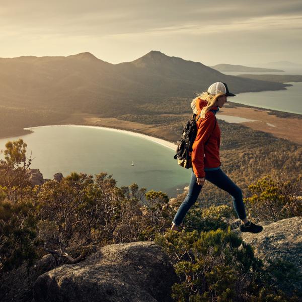 Full length shot of a young woman hiking through the mountains