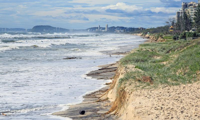 Beach erosion after storm activity Gold Coast Australia, pristine sandy beaches left with dangerous scarping and dark sands visible.