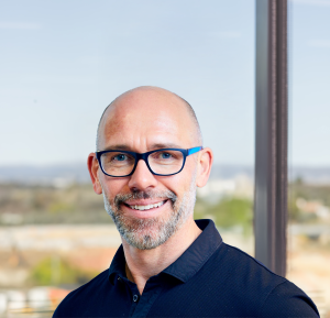 Tim Reed in front of a window in Canberra, ACT